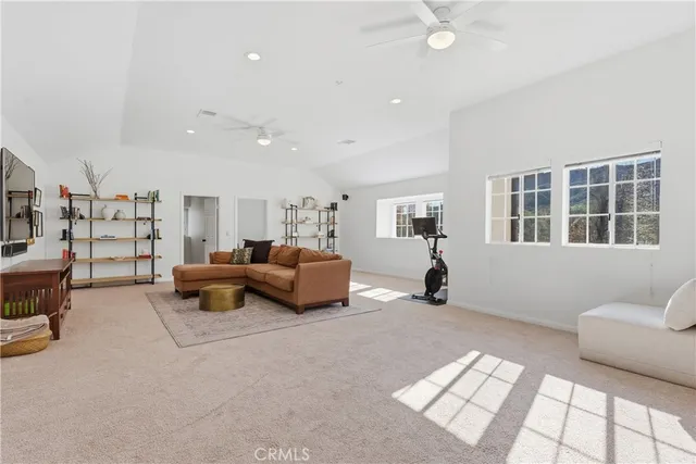 a bedroom with furniture and a large window