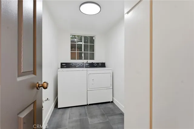 a room with a granite countertop sink and a window