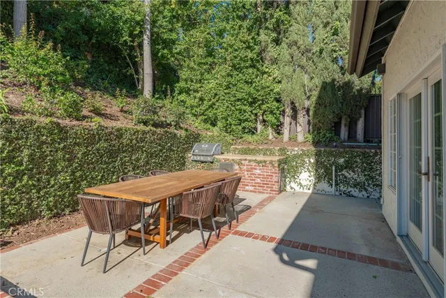 a view of a patio with table and chairs and potted plants