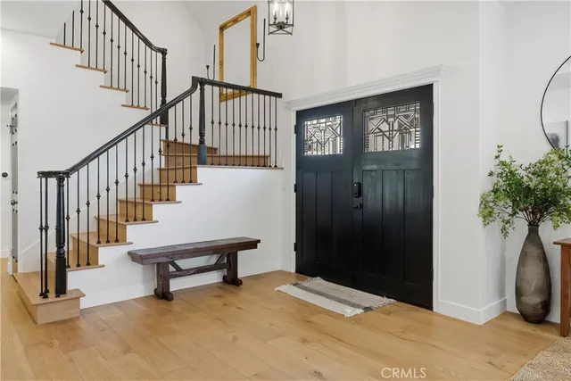 a view of an entryway with wooden floor and windows