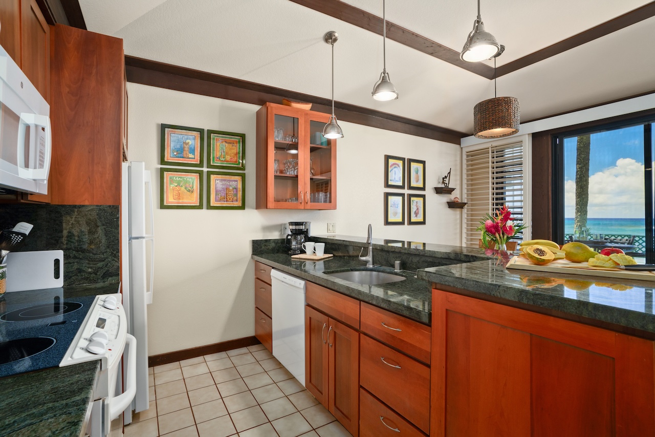 2253 Poipu Road, Unit 192 Koloa, HI 96756 - Photo 11 of 27 a kitchen with granite countertop a sink stove and cabinets