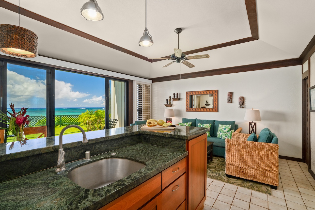 2253 Poipu Road, Unit 192 Koloa, HI 96756 - Photo 7 of 27 a kitchen with a sink a counter top space and living room view