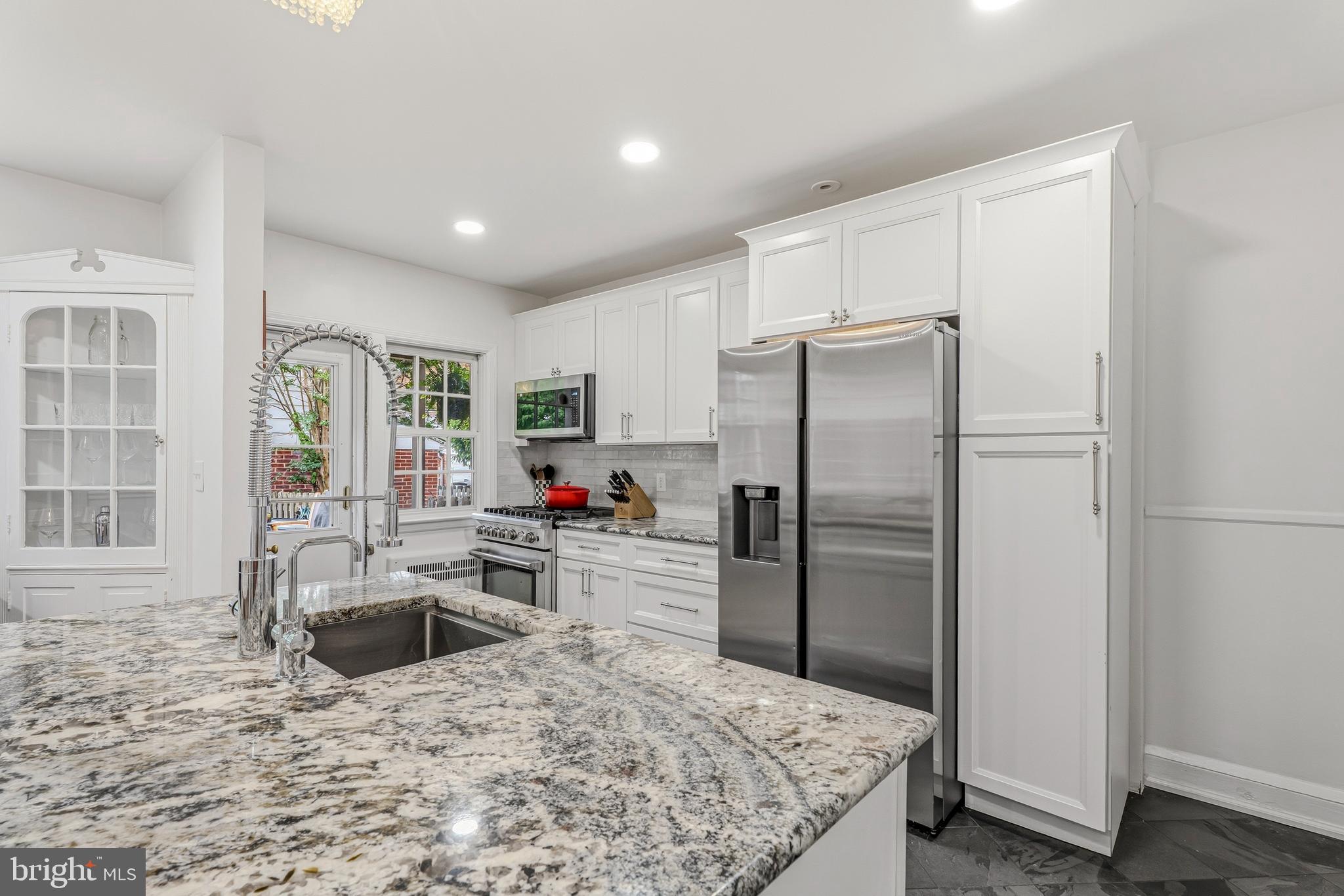 314 Murdock Road Baltimore, MD 21212 - Photo 13 of 42 a kitchen with granite countertop a refrigerator and a stove top oven