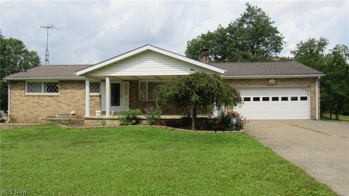 Brick exterior with white siding accents and a covered front entry