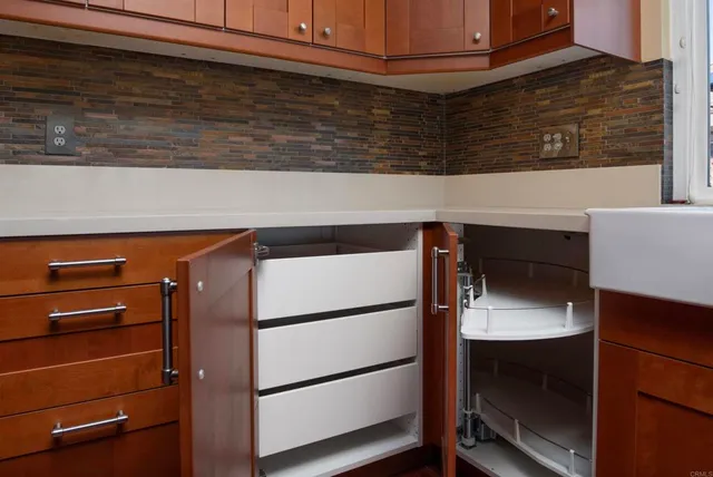 a kitchen with refrigerator and cabinets