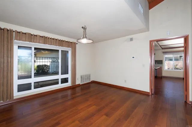 a view of a room with wooden floor and window