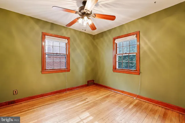 a bedroom with window and ceiling fan