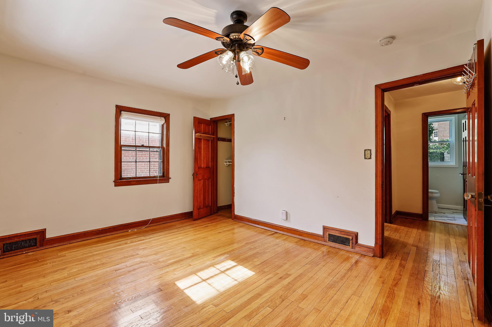 3429 Carpenter Street Southeast Washington, DC 20020 - Photo 13 of 27 wooden floor in an empty room with a window