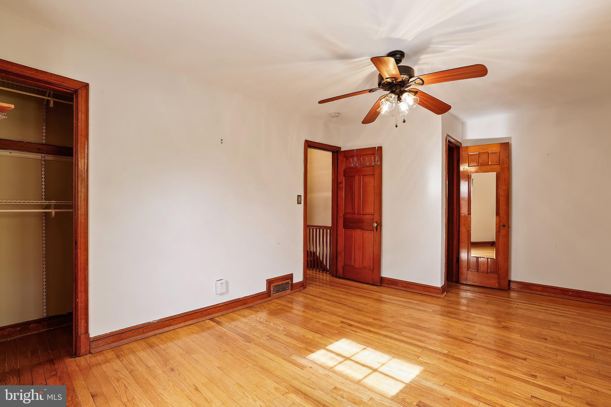 3429 Carpenter Street Southeast Washington, DC 20020 - Photo 16 of 27 a view of a room with wooden floor and ceiling fan
