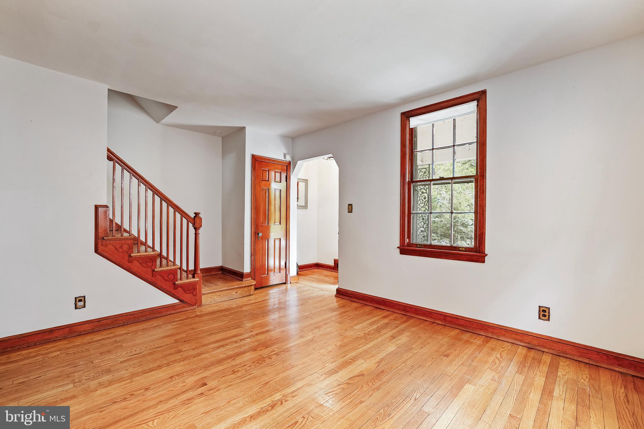 3429 Carpenter Street Southeast Washington, DC 20020 - Photo 3 of 27 a view of an empty room with wooden floor and a window