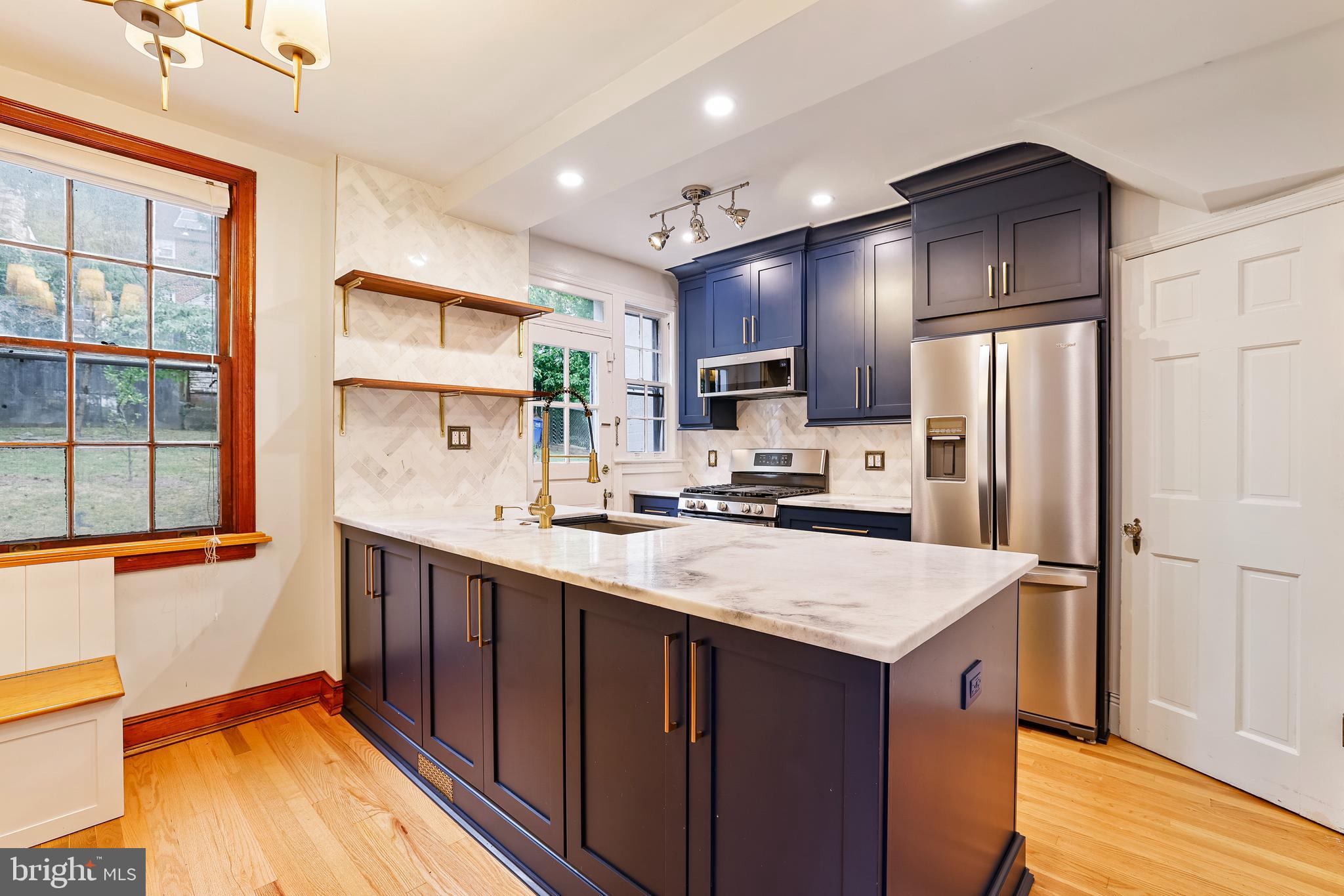 3429 Carpenter Street Southeast Washington, DC 20020 - Photo 6 of 27 a kitchen with kitchen island granite countertop a sink stove and refrigerator