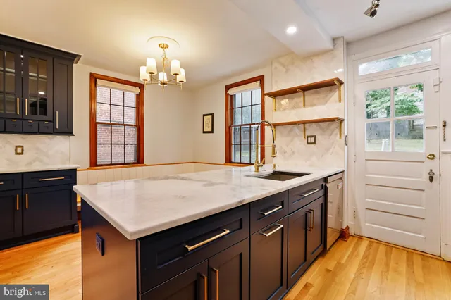 a kitchen with a stove cabinets and wooden floor