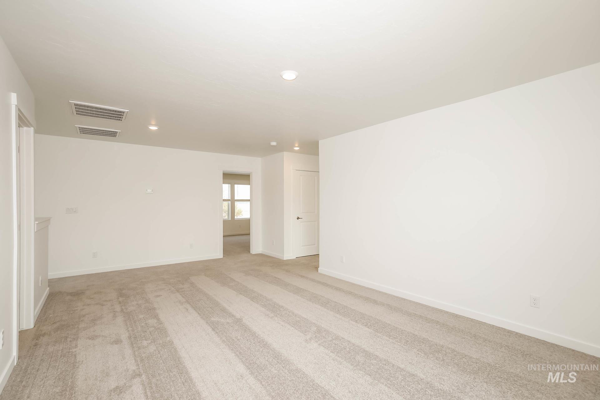 1918 East Springloyd Street Meridian, ID 83642 - Photo 12 of 20 Neutral carpet flooring, recessed lighting, white walls, and white trim throughout