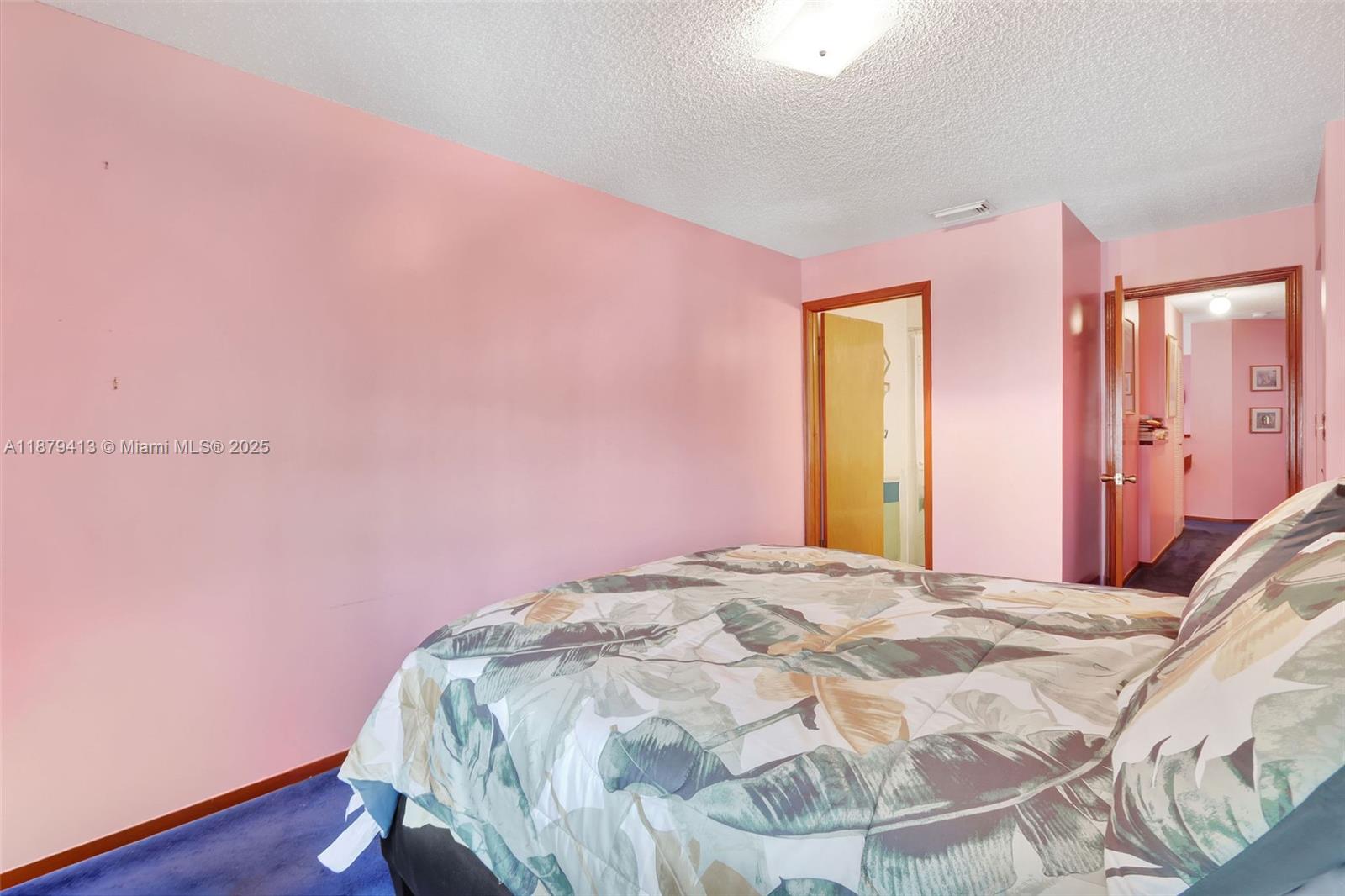 20717 Southwest 81st Place Cutler Bay, FL 33189 - Photo 13 of 23 a bed room with a bed and a mirror