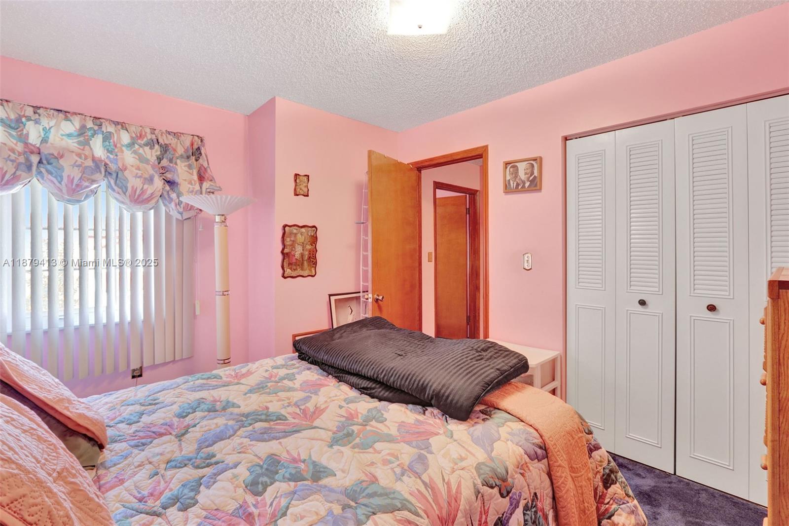 20717 Southwest 81st Place Cutler Bay, FL 33189 - Photo 15 of 23 a bedroom with a bed and a window