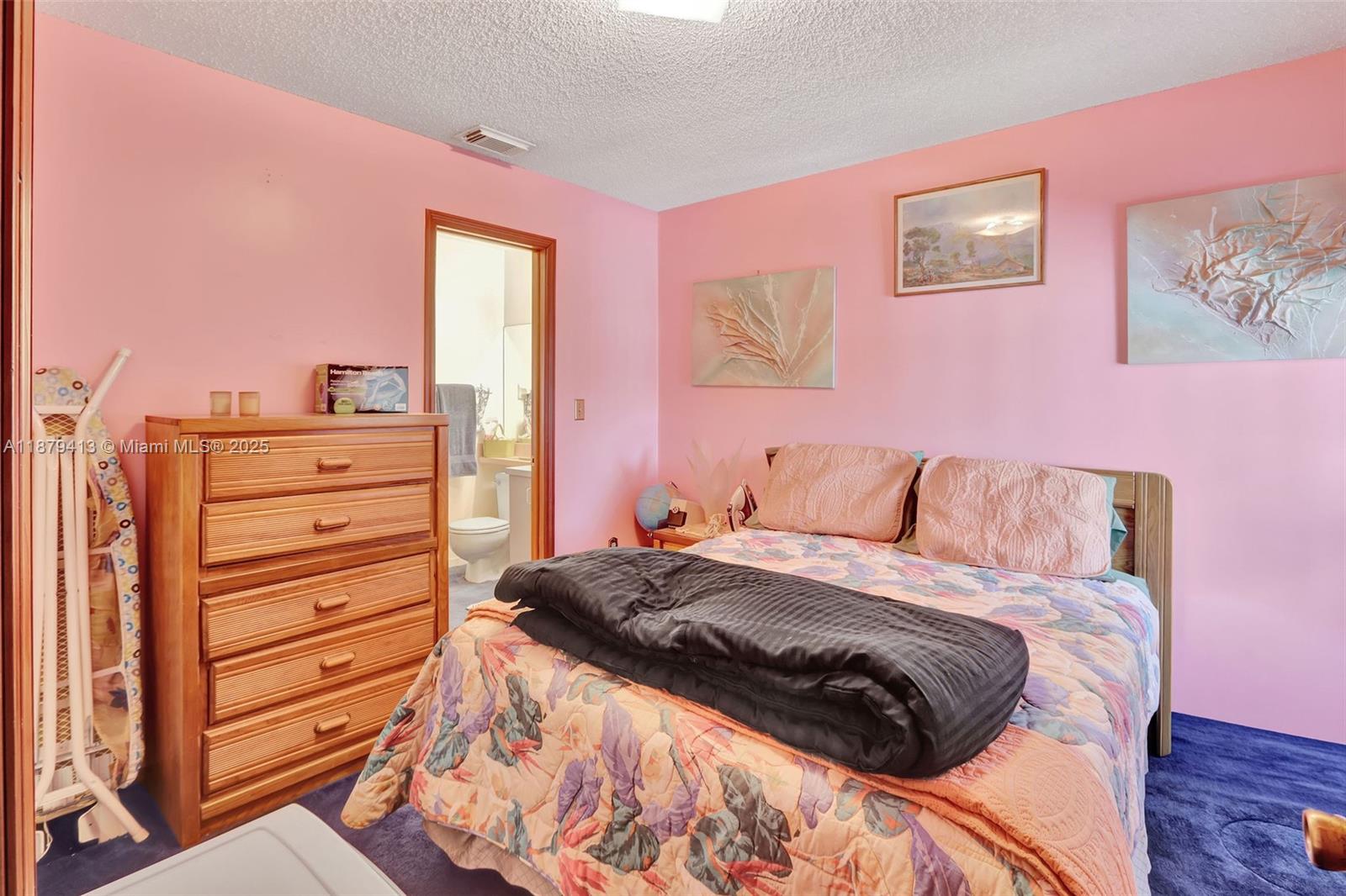 20717 Southwest 81st Place Cutler Bay, FL 33189 - Photo 16 of 23 a bedroom with a bed and a dresser