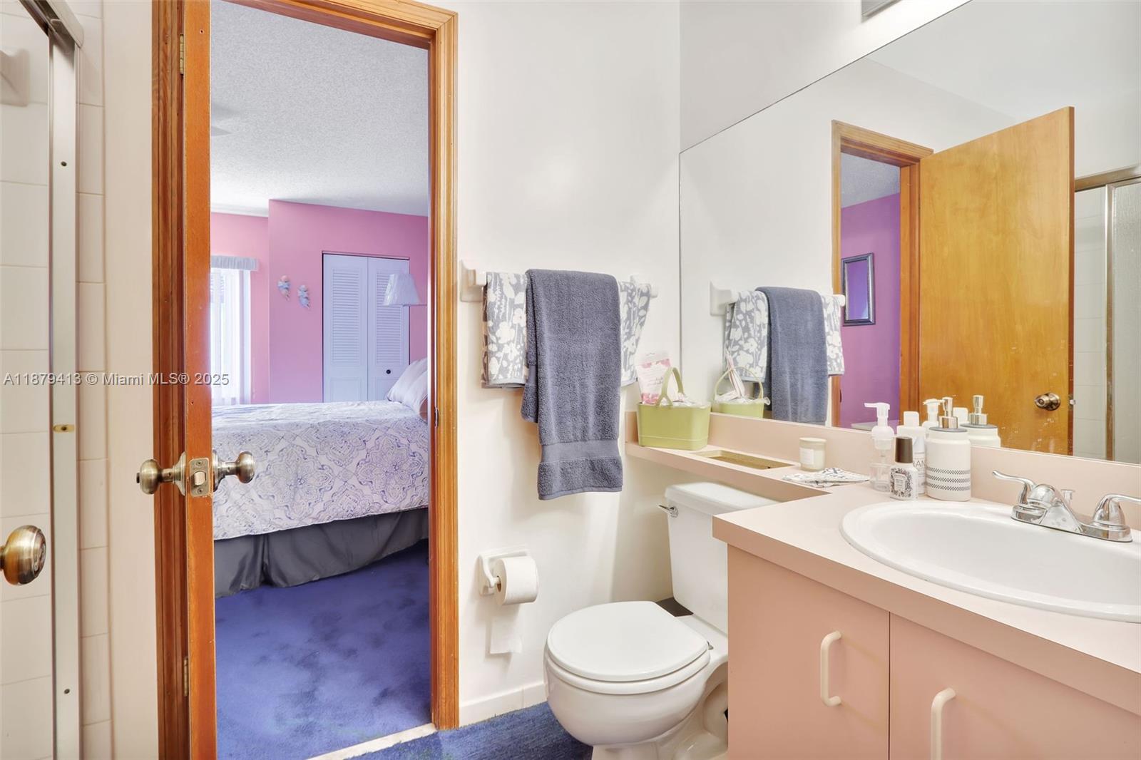 20717 Southwest 81st Place Cutler Bay, FL 33189 - Photo 17 of 23 a bathroom with a granite countertop sink mirror vanity and toilet