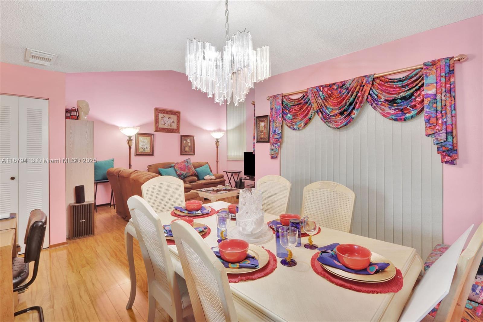 20717 Southwest 81st Place Cutler Bay, FL 33189 - Photo 3 of 23 a view of a dining room with furniture and chandelier