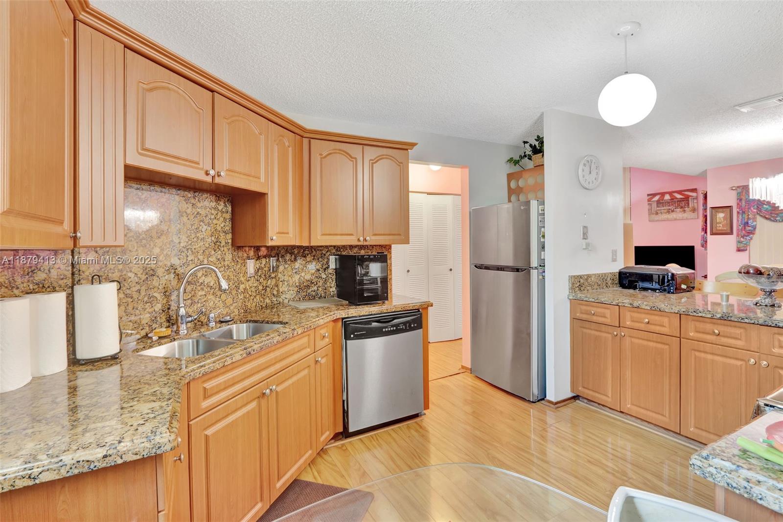 20717 Southwest 81st Place Cutler Bay, FL 33189 - Photo 7 of 23 a kitchen with stainless steel appliances granite countertop a refrigerator sink and stove