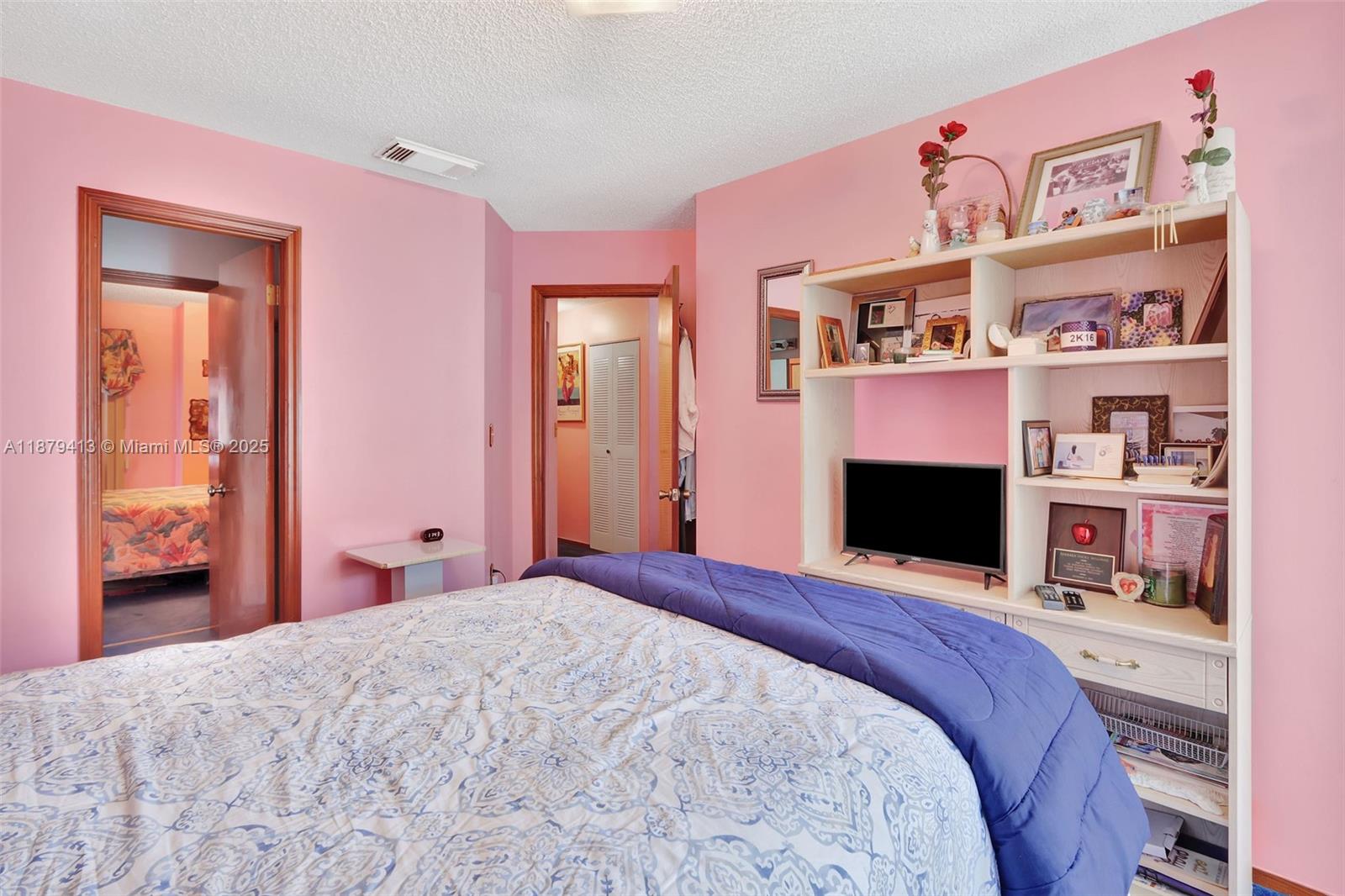 20717 Southwest 81st Place Cutler Bay, FL 33189 - Photo 10 of 23 a bedroom with a bed and a fireplace