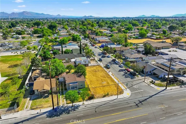 an aerial view of residential houses with outdoor space and swimming pool
