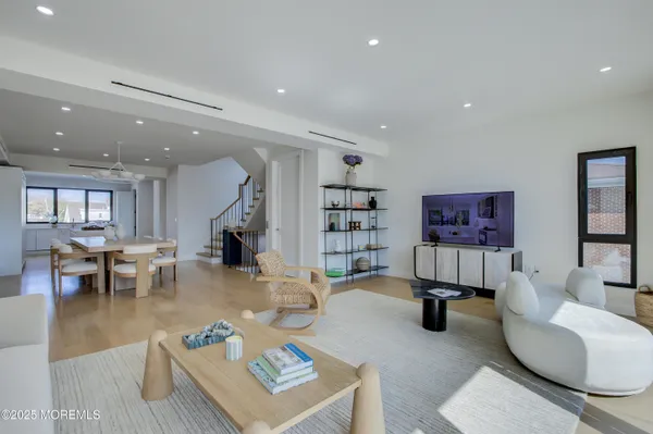 a living room with furniture a rug and gym equipment