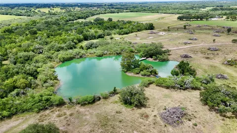 a view of a lake with beach and outdoor space