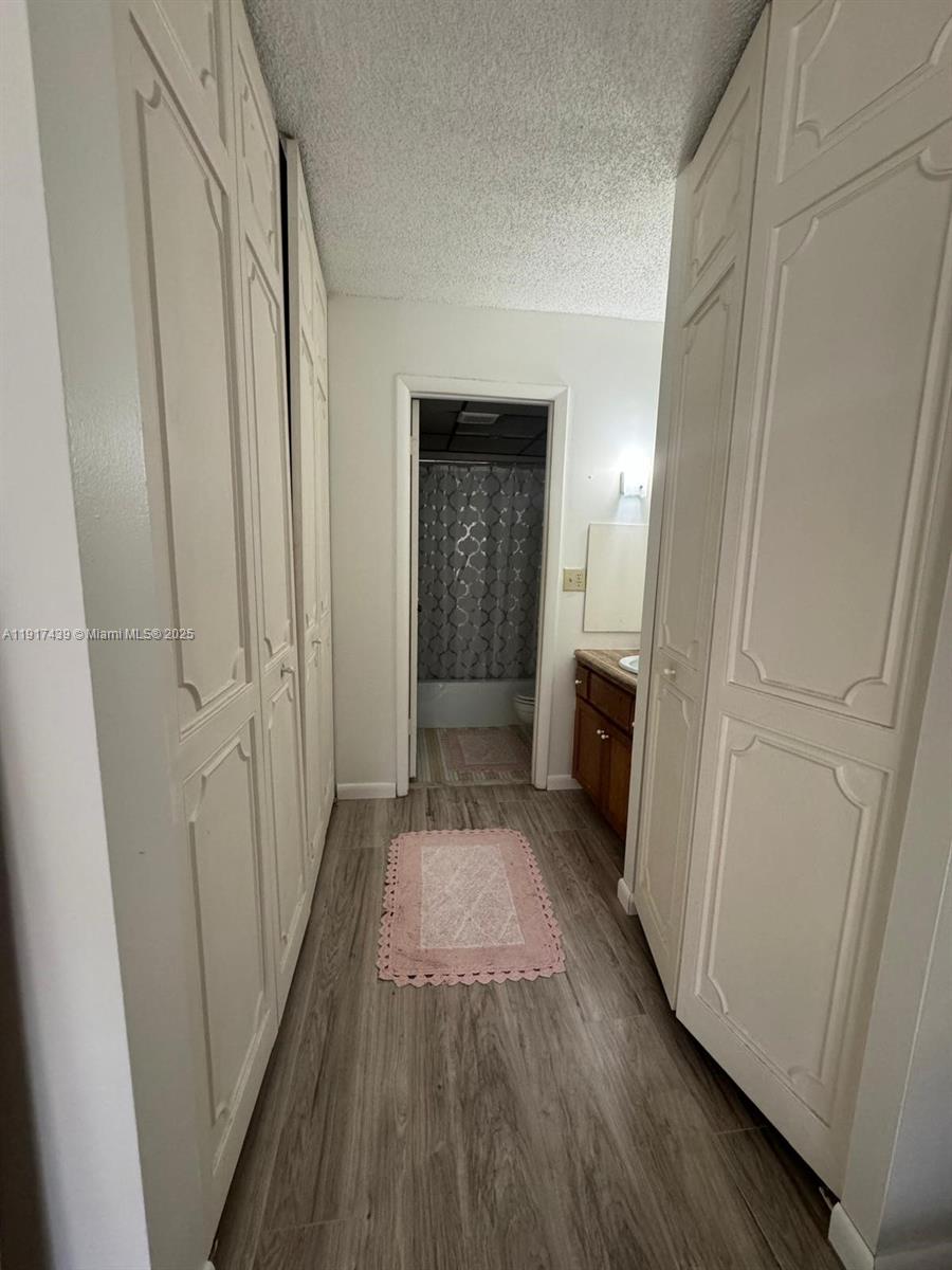 3730 Inverrary Drive, Unit 3U Lauderhill, FL 33319 - Photo 11 of 37 a view of a hallway with wooden floor and staircase