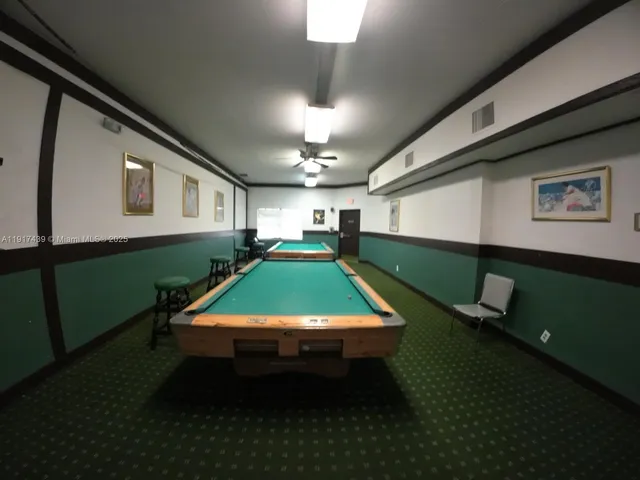 a room with furniture pool table and flat screen tv