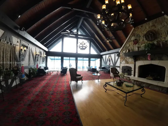 a living room with patio furniture and a fireplace