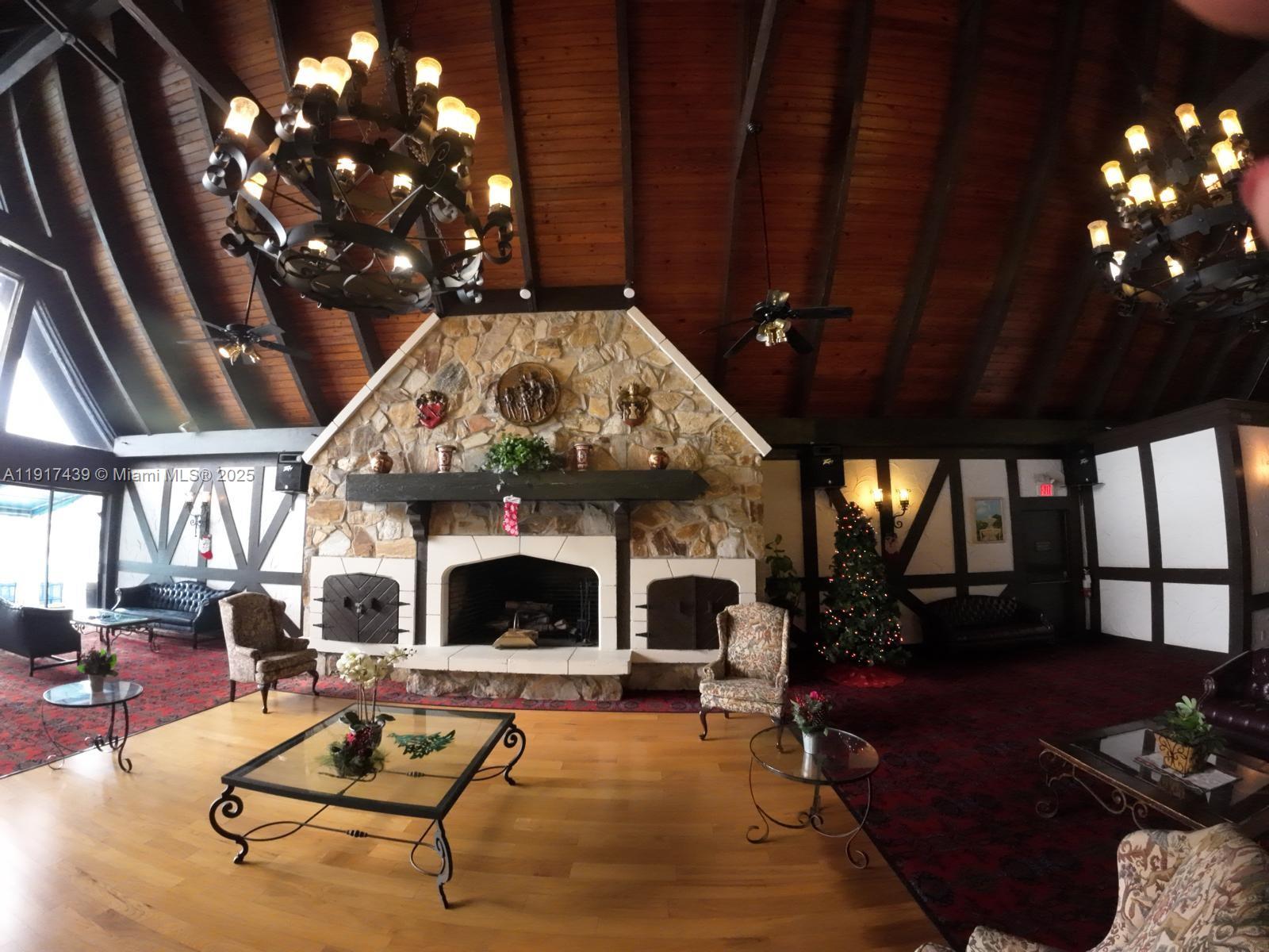 3730 Inverrary Drive, Unit 3U Lauderhill, FL 33319 - Photo 17 of 37 a living room with furniture a fireplace and a chandelier