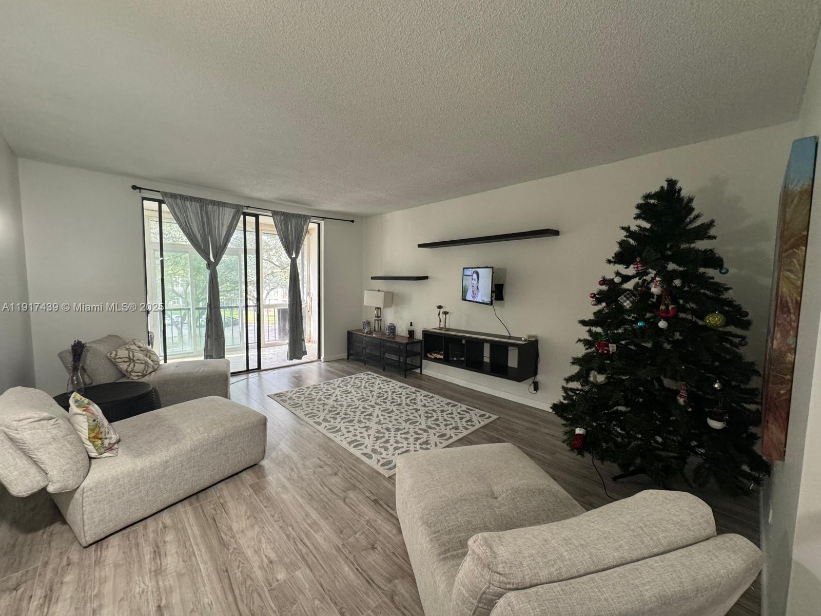 3730 Inverrary Drive, Unit 3U Lauderhill, FL 33319 - Photo 2 of 37 a living room with furniture and a large window