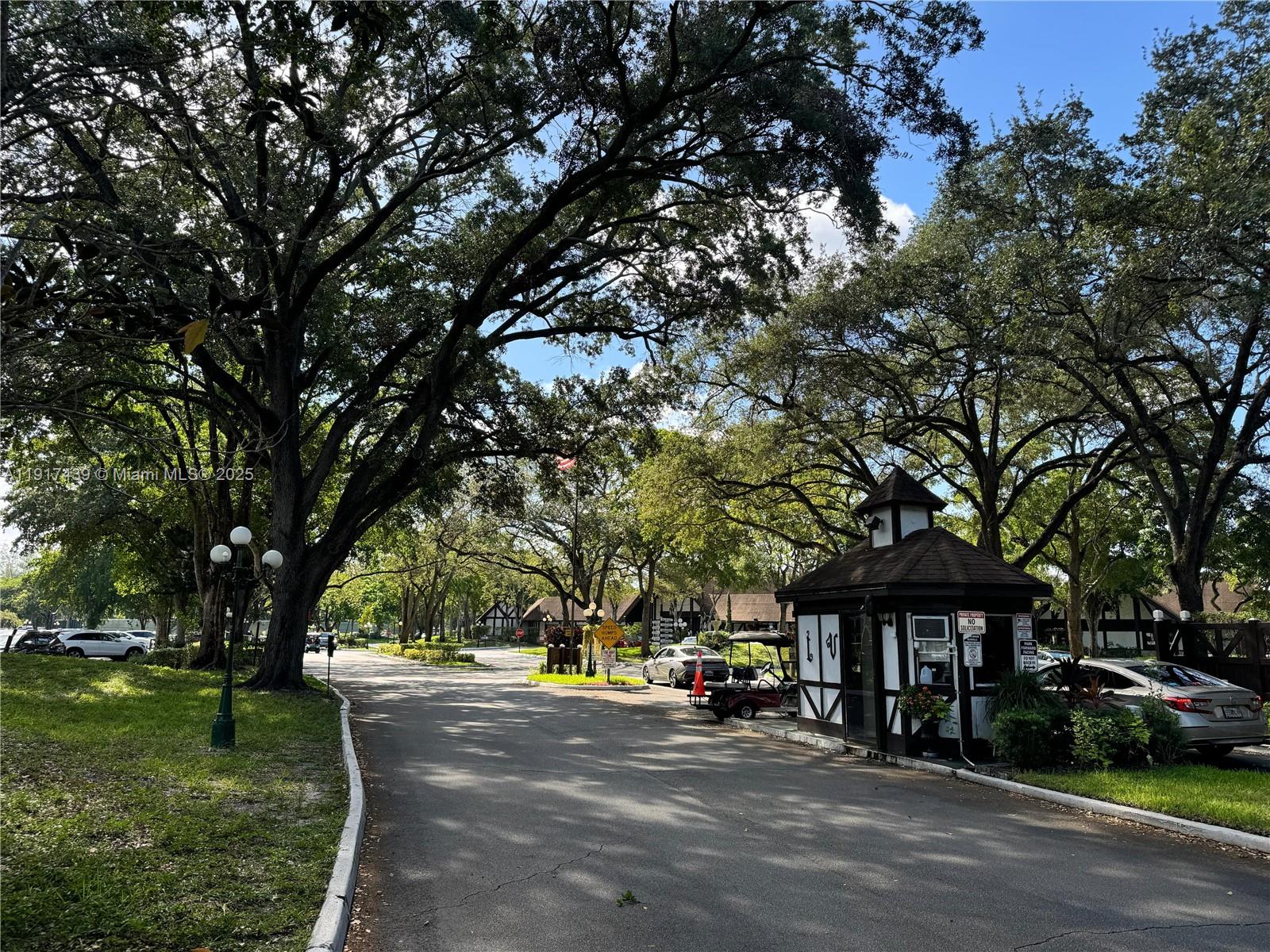 3730 Inverrary Drive, Unit 3U Lauderhill, FL 33319 - Photo 22 of 37 a street view with large trees