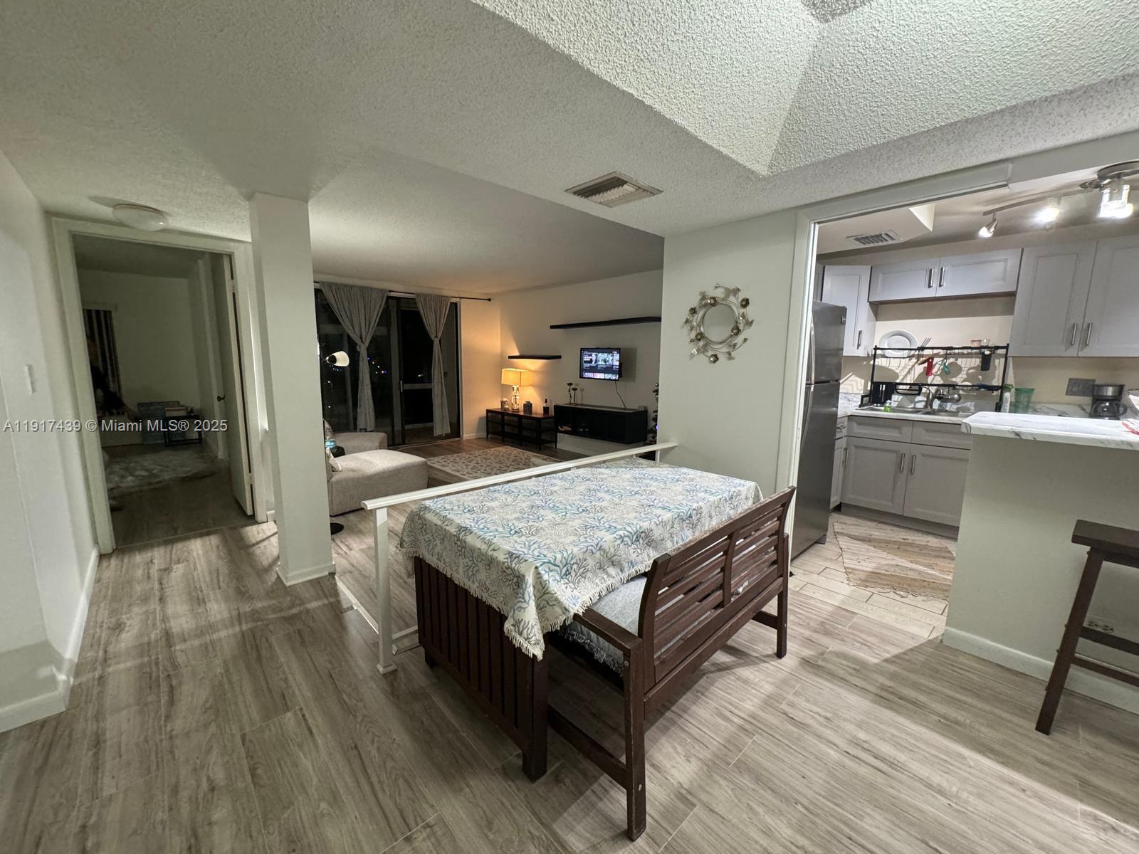 3730 Inverrary Drive, Unit 3U Lauderhill, FL 33319 - Photo 5 of 37 a living room with a table chairs and kitchen view