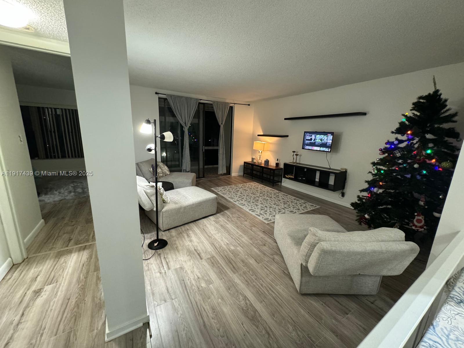 3730 Inverrary Drive, Unit 3U Lauderhill, FL 33319 - Photo 6 of 37 a living room with furniture and a potted plant