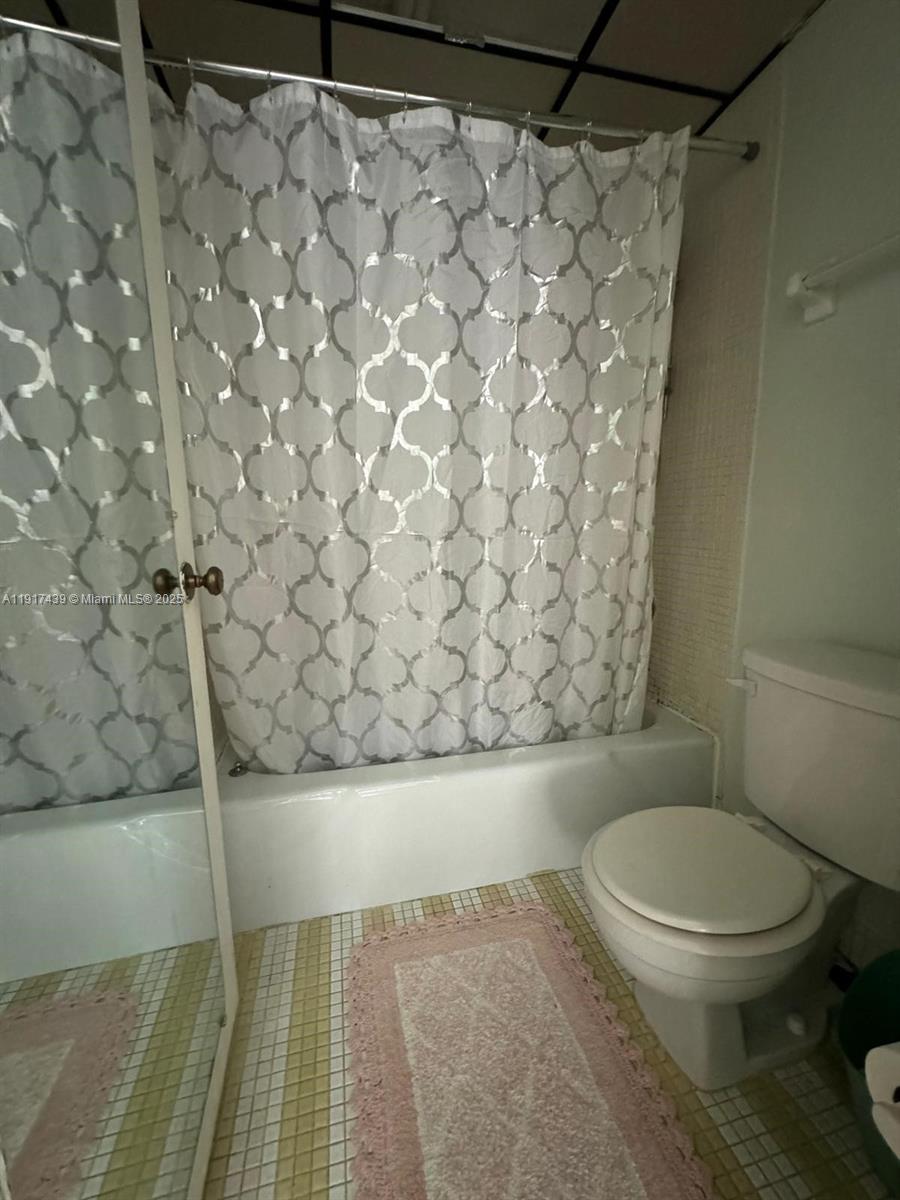 3730 Inverrary Drive, Unit 3U Lauderhill, FL 33319 - Photo 9 of 37 a white toilet sitting next to a shower curtain