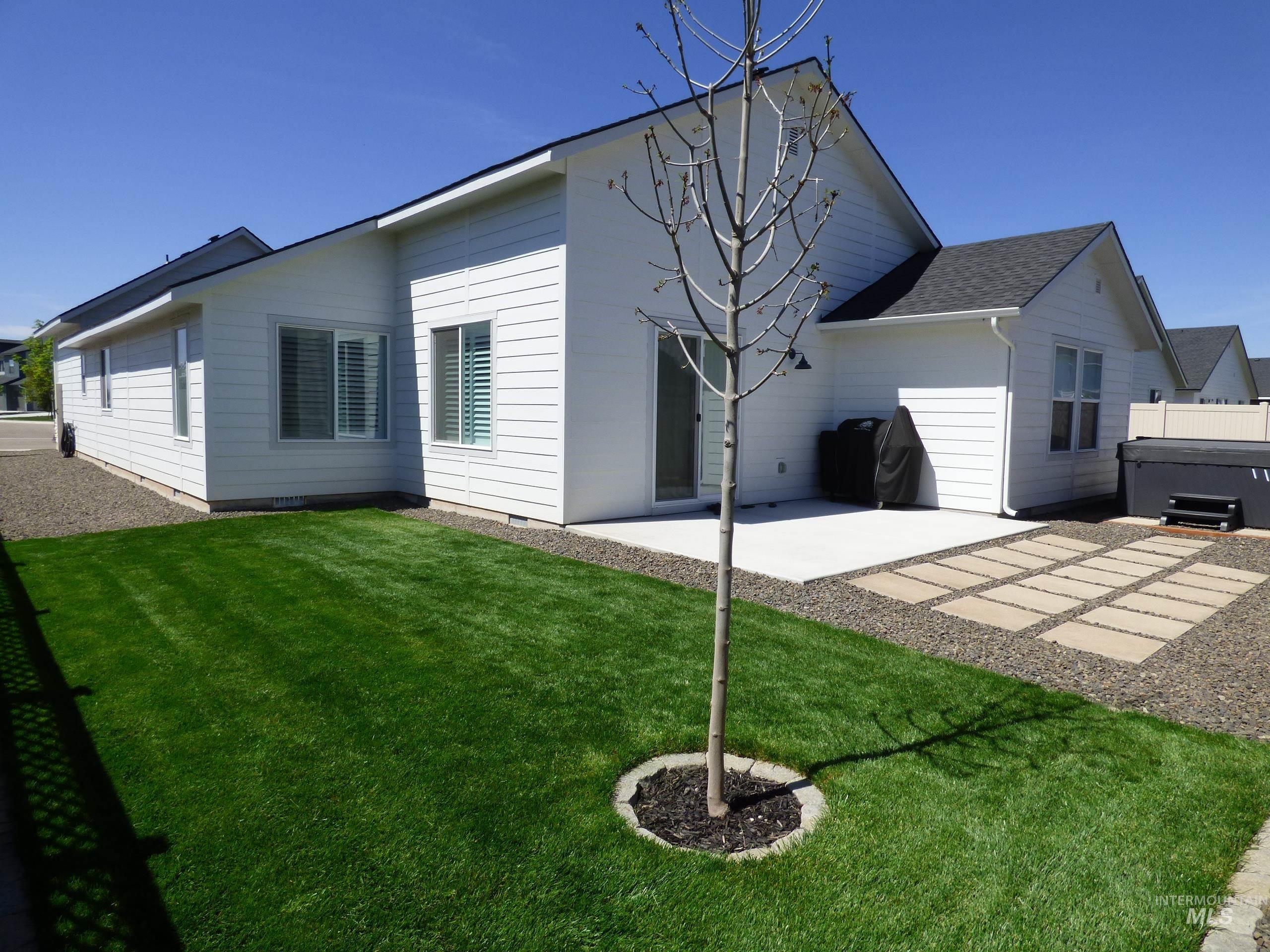 2708 East Buckaroo Drive Kuna, ID 83634 - Photo 36 of 48 Expansive green lawn alongside a concrete patio and a stone paver section