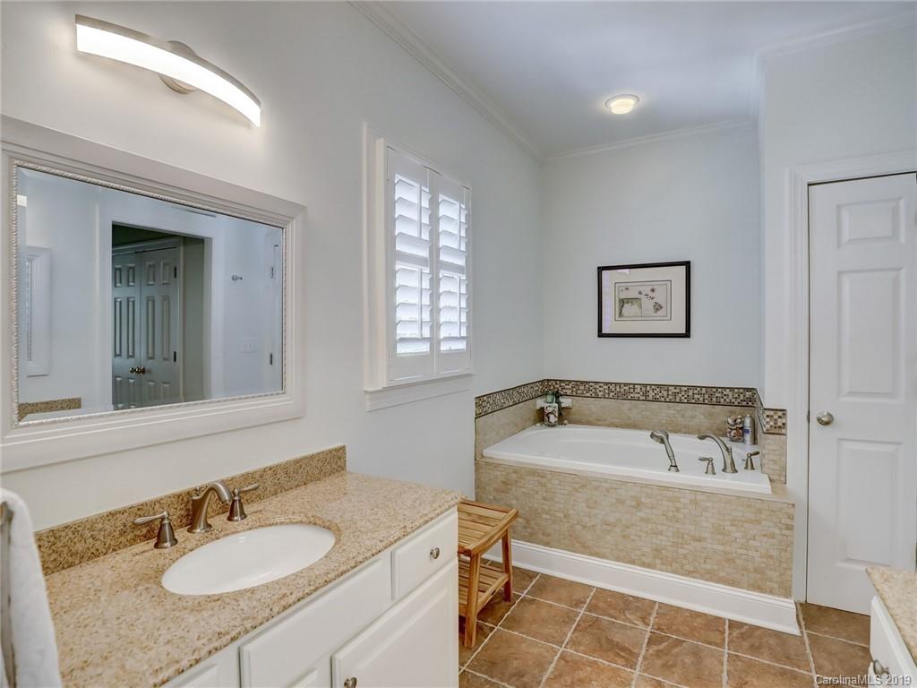 2533 Lower Assembly Drive Fort Mill, SC 29708 - Photo 38 of 48 a bathroom with a granite countertop tub sink and mirror