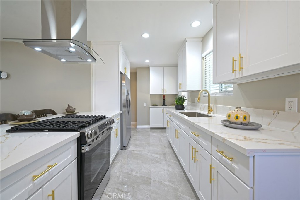 10028 Mildred Court Riverside, CA 92503 - Photo 14 of 50 a kitchen with a stove and a sink