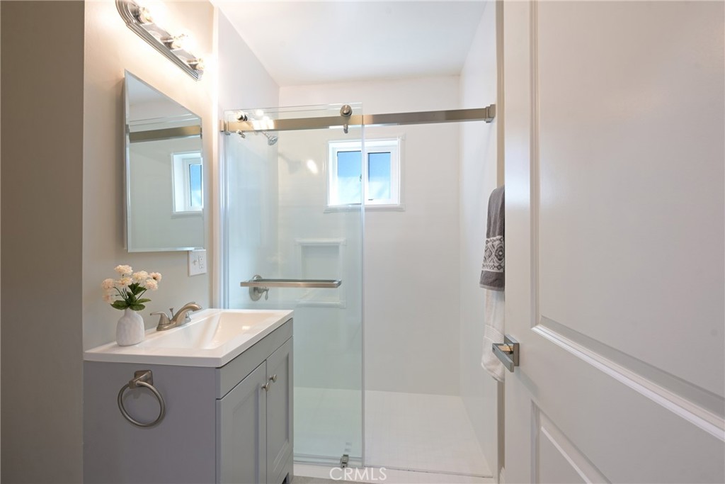 10028 Mildred Court Riverside, CA 92503 - Photo 21 of 50 a bathroom with a sink mirror vanity and toilet