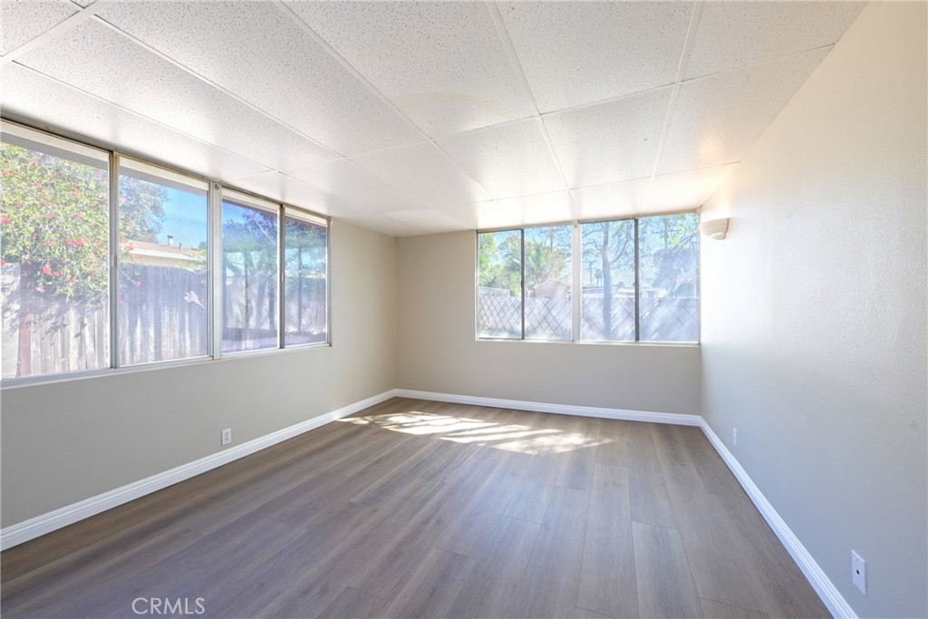 10028 Mildred Court Riverside, CA 92503 - Photo 24 of 50 an empty room with wooden floor and windows