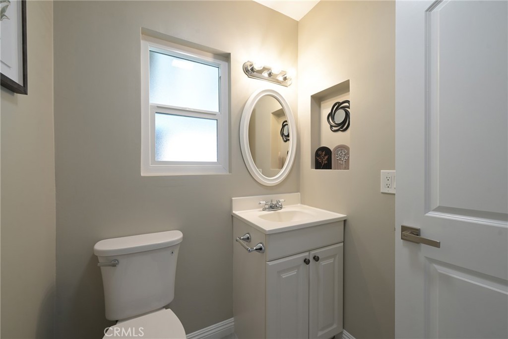 10028 Mildred Court Riverside, CA 92503 - Photo 26 of 50 a bathroom with a toilet sink and mirror