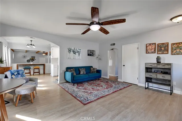 a living room with furniture and a wooden floor