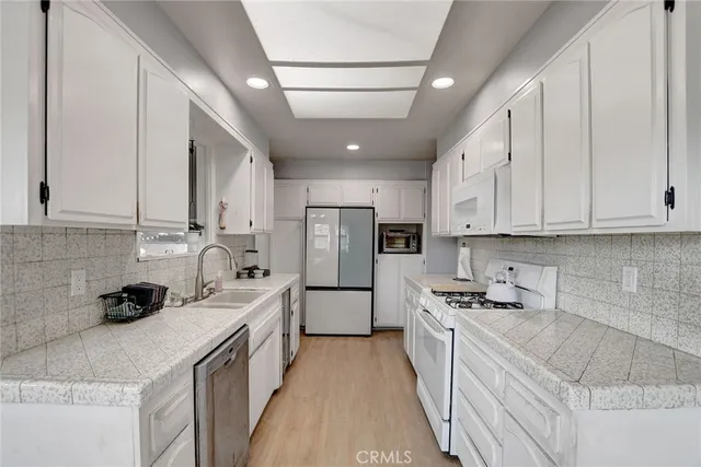 a kitchen with a sink stove and cabinets