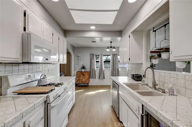 a kitchen with a sink stove and cabinets
