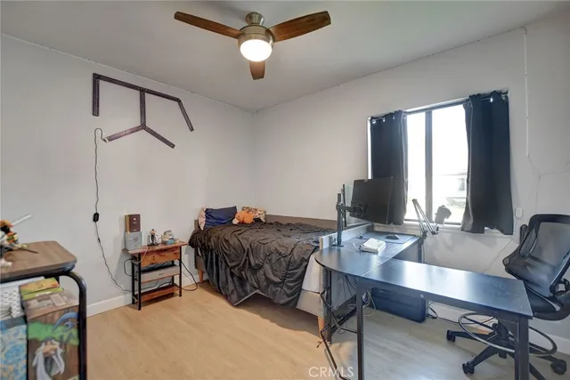 a bedroom with a bed chandelier and a window