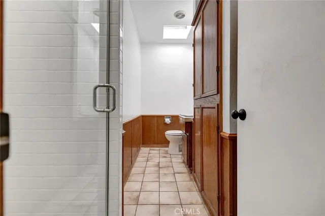 a bathroom with a granite countertop sink a toilet and shower