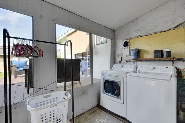 a view of a patio with table and chairs with wooden floor and fence
