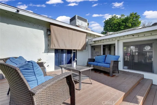 a view of a house with backyard and sitting area