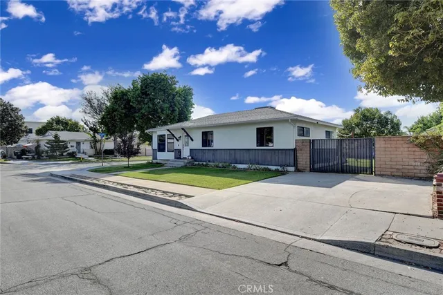 a view of a house with a backyard